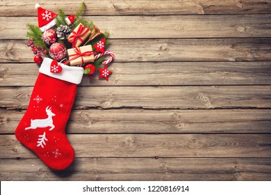 Christmas stocking and toys over rustic wooden background - Powered by Shutterstock