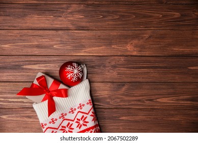 Christmas stocking white close-up with gifts hanging on a wooden wall. Place for your text. - Powered by Shutterstock