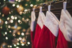 Christmas Stockings Hanging Near Tree On Mantle