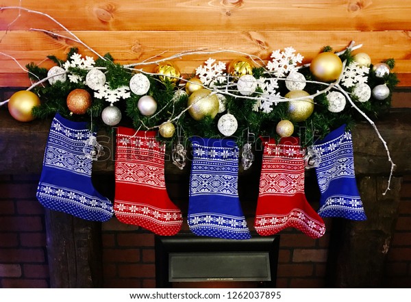 Christmas Stockings Hanging On Decorative Garland Stock Photo