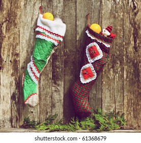 Christmas Stockings Hung On A Rustic Wall.