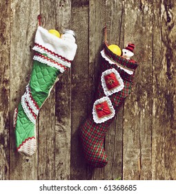 Christmas Stockings Hung On A Rustic Wall.