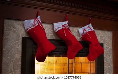 Christmas Stockings On The Fireplace With Candy Canes Hung Outside