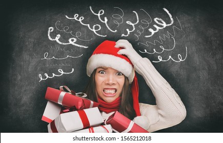 Christmas Stress Winter Holiday Shopping Gifts Woman In Santa Hat Stressed Out Funny Drawings Of Headache Spirals On Black Blackboard Banner Panorama. Anxious Shopper Late For Family Gifts.