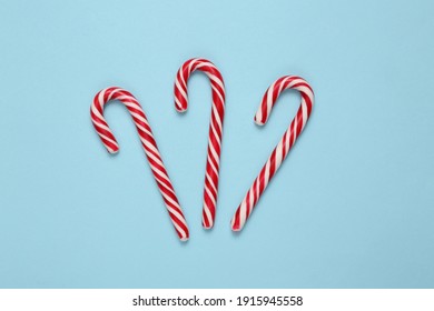 Christmas Striped Candy Canes On A Blue Background.