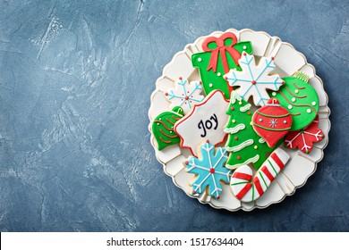 Christmas Sugar And Gingerbread Cookies Decorated With Royal Icing On A Plate Overhead