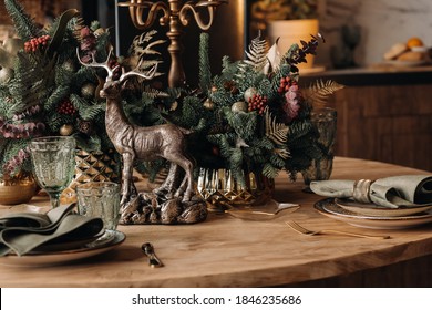 Christmas Table Decoration, Banquet Table With Glasses Before Serving Food, Close-up Of Christmas Dinner Table With Seasonal Decorations, Crystal Glasses And Decorative Deer