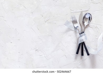 Christmas table place setting. Christmas serving cutlery on a concrete background. Christmas and New Year holidays background