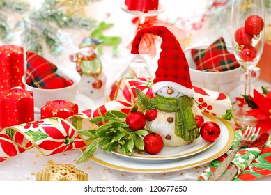 Christmas Table Set With Funny Snowman In Red Cap On The Plate