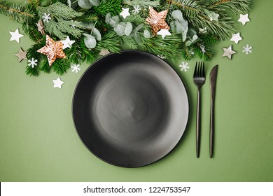 Christmas Table Setting. Black Tableware And Decoration With Fir-tree Branch. Flat Lay, Top View.