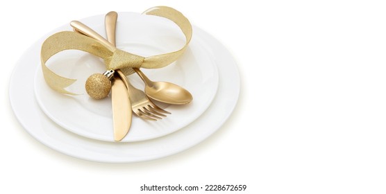 Christmas table setting close up view. Golden cutlery and dishes isolated on white, copy space, top view. Elegance and luxury