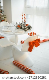 Christmas table setting decorated with candy canes and bows with warm festive atmosphere