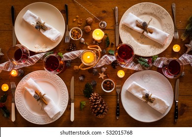 Christmas Table Setting For Family Dinner At A Cosy Rustic Table With Candles And Decorations. Top View.