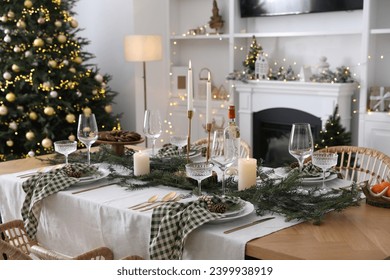 Christmas table setting with festive decor and dishware in living room - Powered by Shutterstock