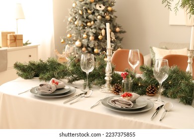 Christmas table setting with fir branches and rowan in dining room - Powered by Shutterstock