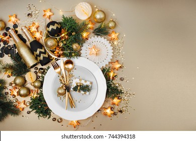 Christmas Table Setting. Gold And Black Decoration With Fir-tree Branch. Flat Lay, Top View. 