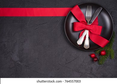 Christmas Table Setting With Plate, Cutlery, Red Ribbon And Berries. Winter Holidays And Festive Background. Christmas Eve Dinner, New Year Food Lunch. View From Above, Top, Horizontal