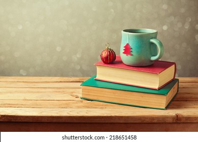 Christmas Tea Cup And Ball On Vintage Books