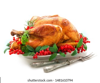 Christmas Or Thanksgiving Turkey Garnished With Red Berries And Sage Leaves Isolated On White Background