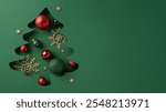 Christmas theme featuring a tree cutout filled with red and green ornaments, snowflakes, and stars on a green backdrop, symbolizing holiday creativity and joy