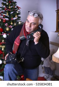  Christmas Theme. Senior Man Talking On Vintage Land Line Phone