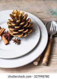 Christmas themed table setting with pinecone on the plate