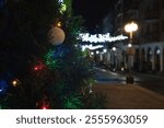 CHRISTMAS TIME - Christmas decorations and lights on tree branches on a city street