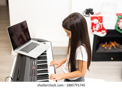 Christmas Time, Laptop On Piano Keys, Little Girl Playing Piano