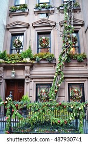 Christmas time on the Upper East Side of New York City. Brownstone decorated with all the Christmas greenery. Garland and window wreaths