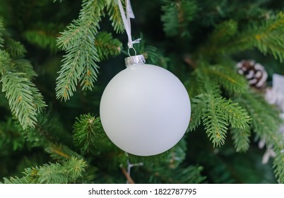 Christmas tinsel with a toy, on a green background close-up - Shutterstock ID 1822787795