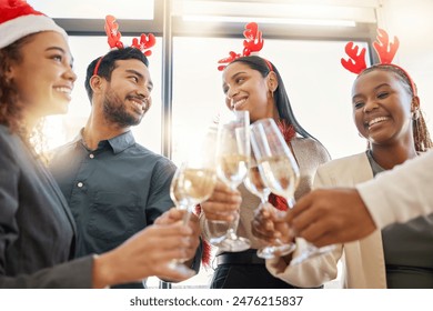 Christmas, toast and friends with alcohol in office for party celebration, social gathering and company lunch. Happy team, diversity and group of people with champagne for festival, cheers or holiday - Powered by Shutterstock