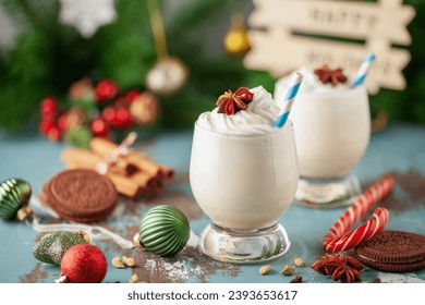 Christmas Tom and Jerry cocktail or eggnog with whipped cream in glasses on decorated background - Powered by Shutterstock