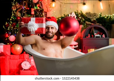 Christmas Tour Concept. Stunning Winter Views Enjoyed From Bathtub. Enjoy New Years Eve Celebrations Book Stay Hotel Apartment. Man Lying In Bathtub With Gift Box. Sexy Hedonist Relax In Bathtub.