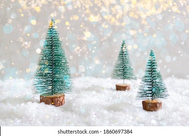 Christmas Toy Trees On Simulated Snow. Beautiful Festive Background For Postcards, Web, Print. Christmas Holiday Celebration Concept