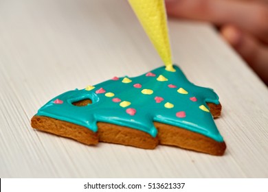 Christmas Treats. Handmade Cookies, Confection Standing On The Table. Female Hands Decorating Gingerbread With Icing Sugar Using A Pipping Bag. Baking Holiday Cookies. Christmas And New Year.