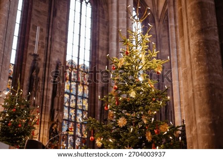 Christmas Tree and Advent Decorations Inside a European Church with Straw Ornaments, Candles, and Warm Holiday Light