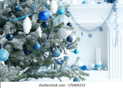 Christmas Tree With Blue And White Toys In The Interior / Christmas Card With White And Blue Decor