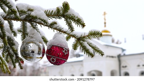 Christmas tree branch with decorations on the background of the Orthodox cross with a crucifix. The Orthodox Church. Winter is Christmas. The concept of Orthodoxy.