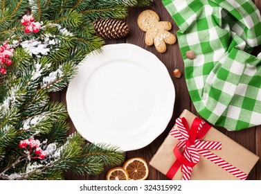 Christmas tree branch, empty plate and coffee. Top view with copy space - Powered by Shutterstock