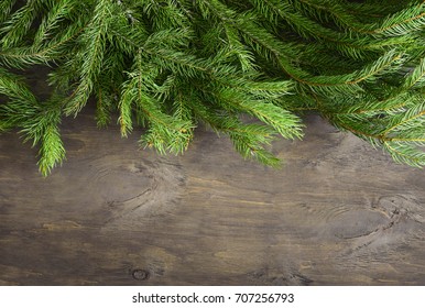 Christmas Tree Branch On A Plain Rustic Background, Flat Lay, Space For A Text