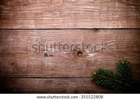 Christmas tree branch on a wooden table or board for background. New year theme. Toned.