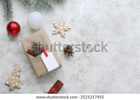 Christmas tree branches with gift box and cookies on white background