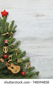 Christmas Tree Branches With Music Notes, Instruments On Wooden 