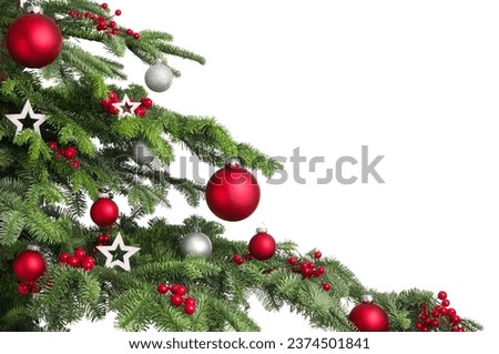 Christmas tree branches on white background. Closeup of decorated fir branches with red and silver baubles, isolated on white