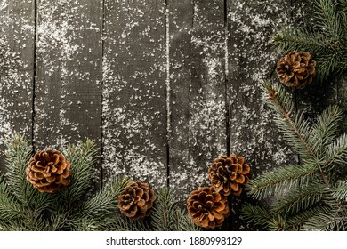 Christmas tree branches, pine cones and fake snow. Festive holiday season flat lay composition with copyspace on wooden background. - Powered by Shutterstock