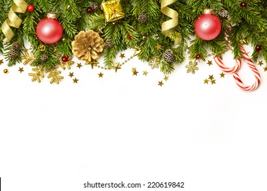 Christmas tree branches with red baubles,  golden stars, snowflakes isolated on white  -  horizontal border - Powered by Shutterstock