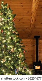 Christmas Tree In Cabin Setting With Wood Stove Burning.