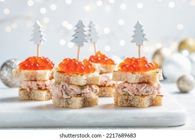 Christmas tree canape with Smoked Salmon, Cream Cheese, Dill, Horseradish Pate and red caviar for festive xmas snack - Shutterstock ID 2217689683