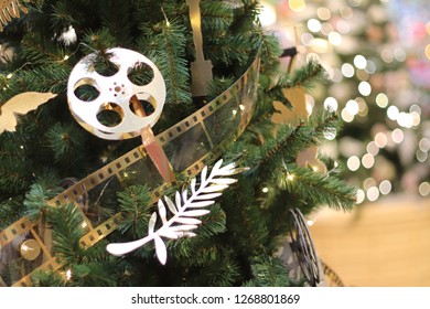 Christmas tree with cinema decorations. Movie decorations on the Christmas tree. Going to the cinema on New Year's holidays - Powered by Shutterstock