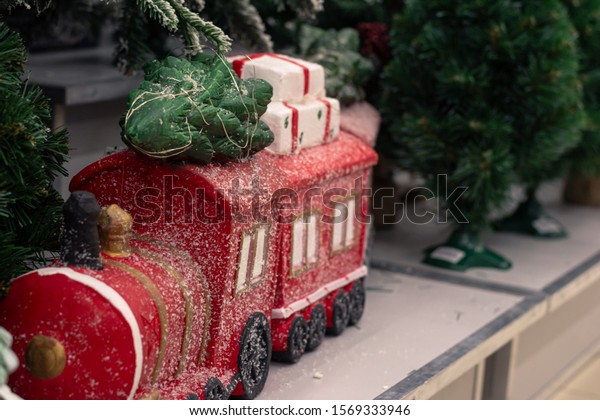 Christmas tree composition\
toy, train on rails with a felled Christmas tree and gifts. New\
Year holiday\

